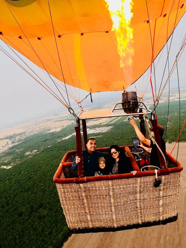 Authors in a hot air balloon flying in the sky