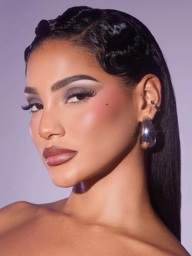 Glamorous woman with sleek hair and bold makeup.