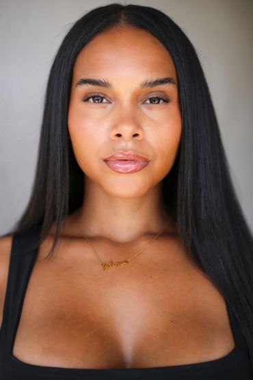 Close-up portrait of a woman with long straight hair.