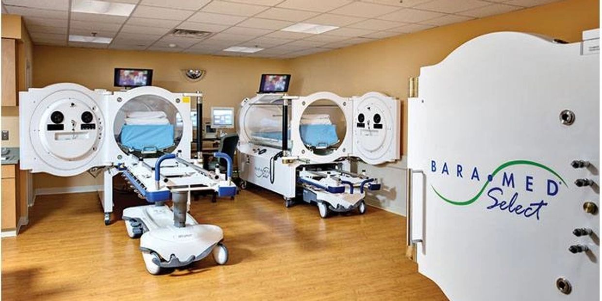 Medical hyperbaric oxygen chambers in a clean treatment room.