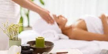 A person receiving a relaxing head massage in a spa setting.