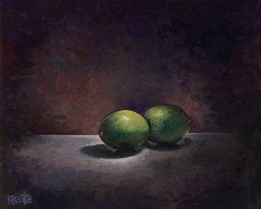 Two green limes on a dark surface.