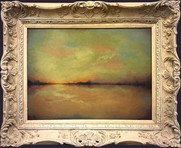 Framed painting of a sunset over calm water.