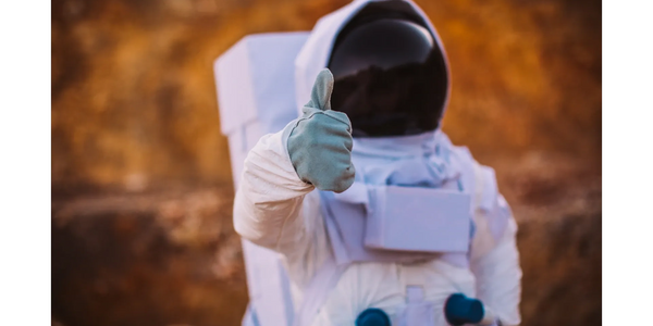 astronaut giving thumbs up after completing mission