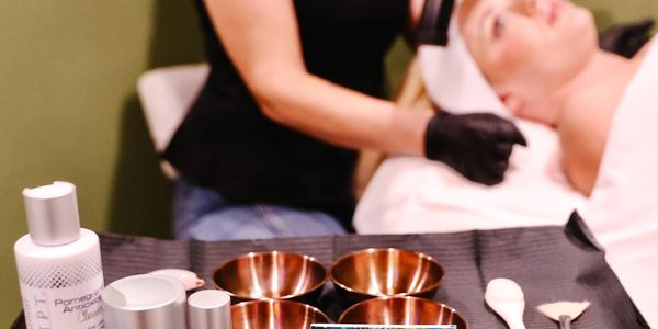 Facial treatment setup with skincare products and tools in a spa.