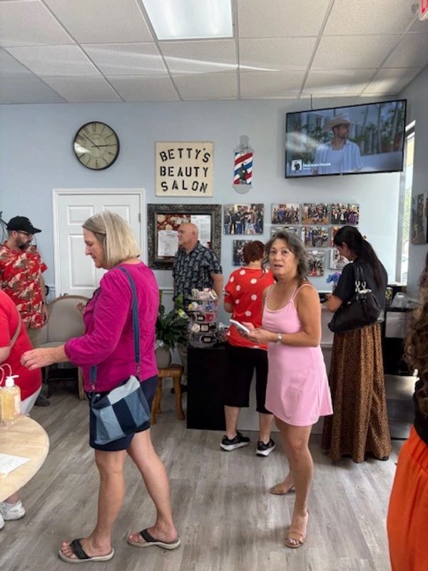 Busy scene inside Betty's Beauty Salon with people interacting.