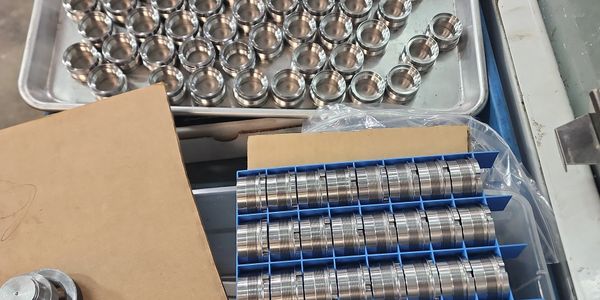 Shiny metal rings neatly organized in trays and boxes.