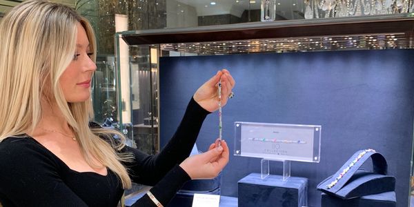 Woman examining jewelry in a store.