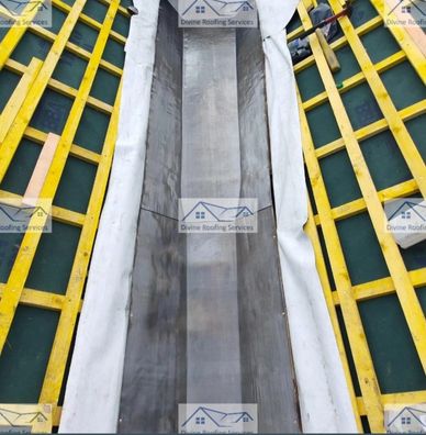 Roof structure with yellow battens and a central metal or waterproof channel.