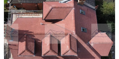 Aerial view of a red-tiled house roof.