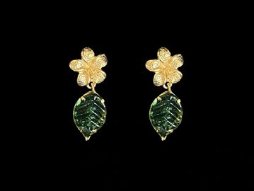 Gold flower earrings with green leaf pendants.