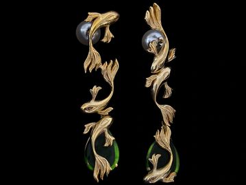 Elegant gold earrings with pearls and green gems.
