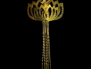 Gold floral hairpin with twisted prongs.