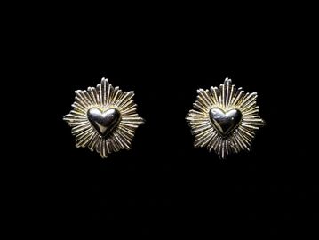 Heart-shaped earrings with radiating design.