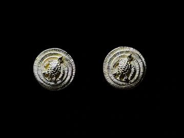 Pair of silver cufflinks with intricate design.