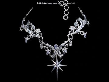 Elegant silver necklace with intricate floral design and star pendant.