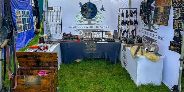 Market stall selling handcrafted jewelry and accessories under a tent.