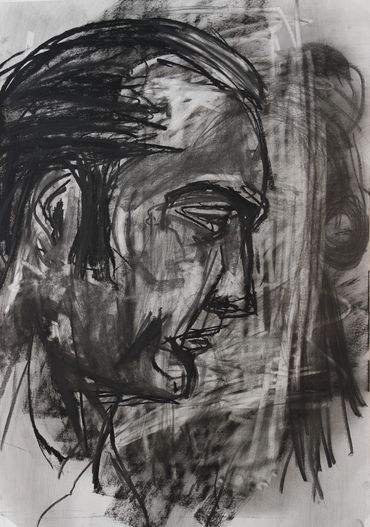 Male profile portrait in charcoal on top of overworked paper