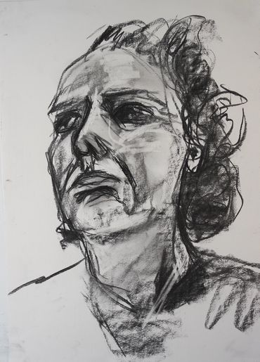 A female portrait is drawn in charcoal using expressive mark making