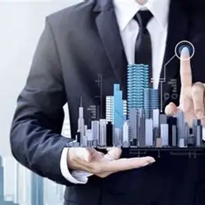 Businessman interacting with a digital cityscape hologram.
