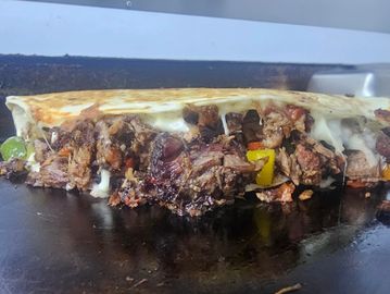 Tri color bell pepper, grilled onions, Monterey jack cheese with your choice of smoked brisket or gr