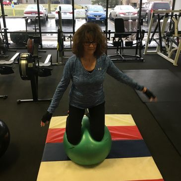 Carol at 70 yrs young balancing on top of a stability ball