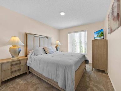 Cozy bedroom with beige walls and modern furniture.