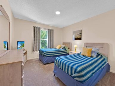 Bedroom with two twin beds and a dresser.