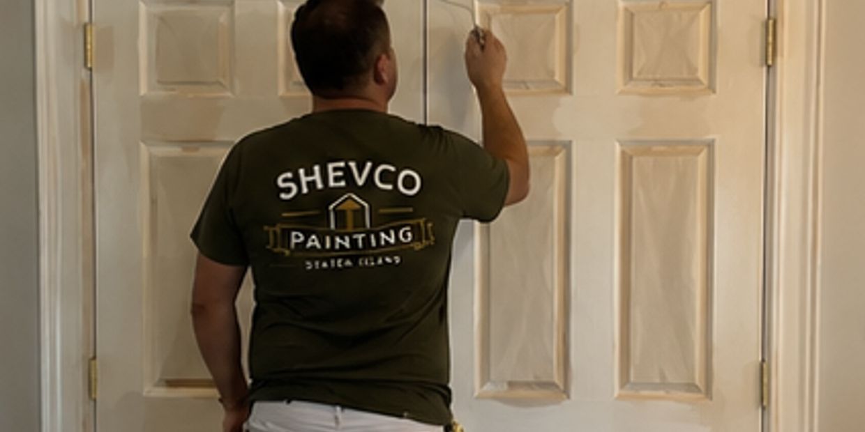 A painter working on a door.