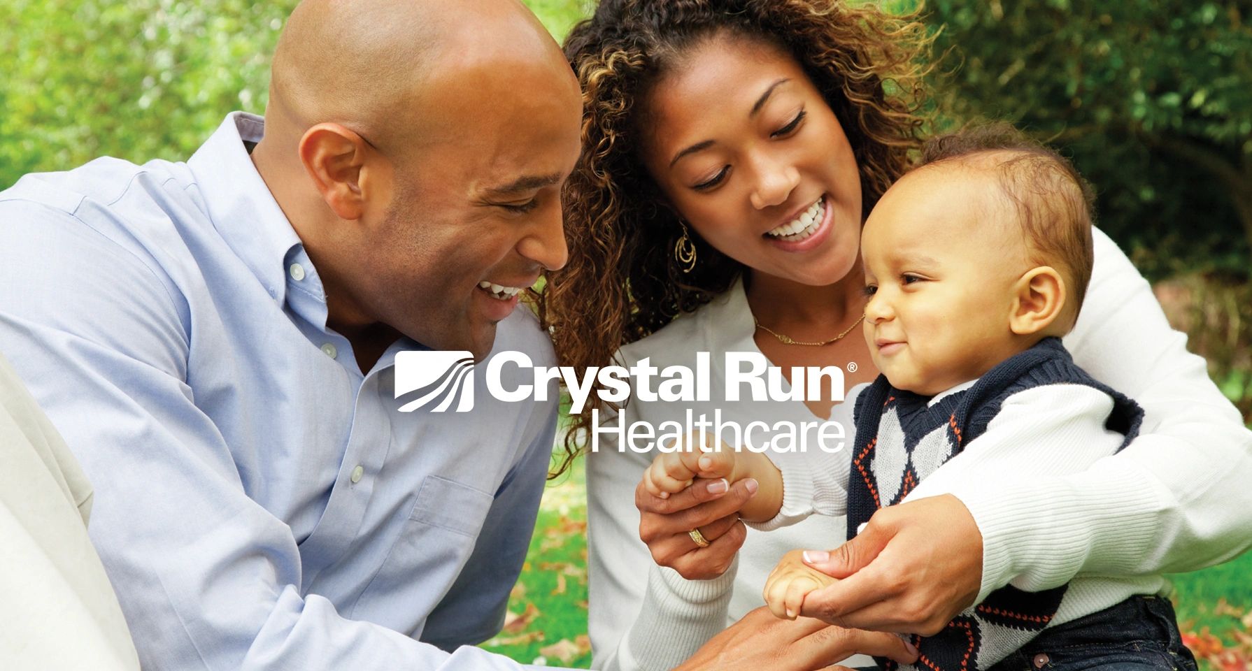 Happy family spending time together outdoors with Crystal Run Healthcare logo.