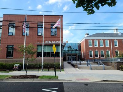 Picture of the entrance to Murch Elementary School with a bike cart for carrying children on a rack.