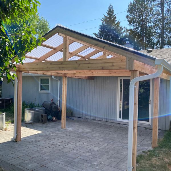Gable-style patio cover. cedar framed with Acrylite Wave roof panels. 