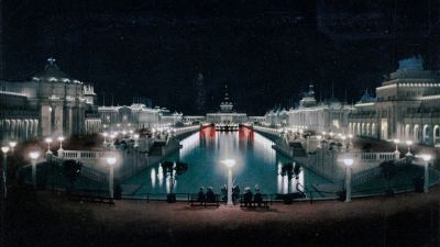A grand illuminated canal and architecture at night.