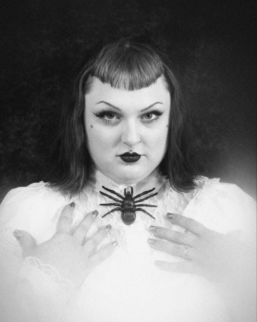 Gothic styled woman with a spider necklace.