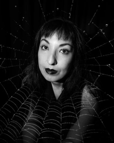 Black and white portrait of a woman with a spider web overlay.