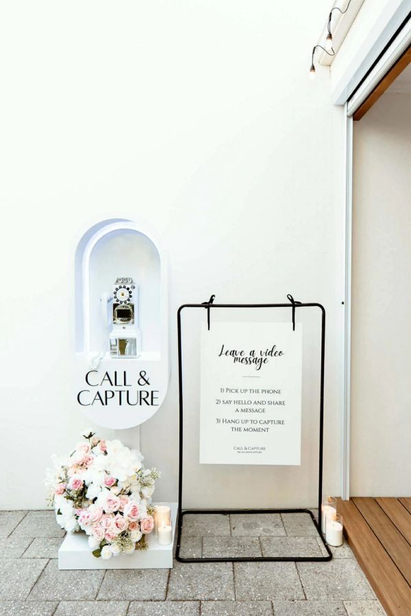 Vintage phone setup with floral decor for leaving video messages.
