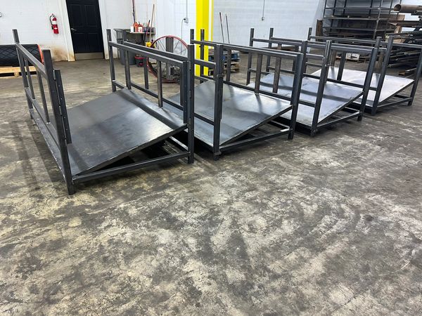 Metal ramps with railings inside an industrial workshop.