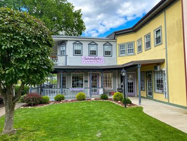 Charming tea room and café with welcoming porch and lush green lawn.