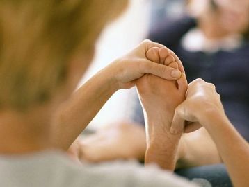 Hands holding a foot