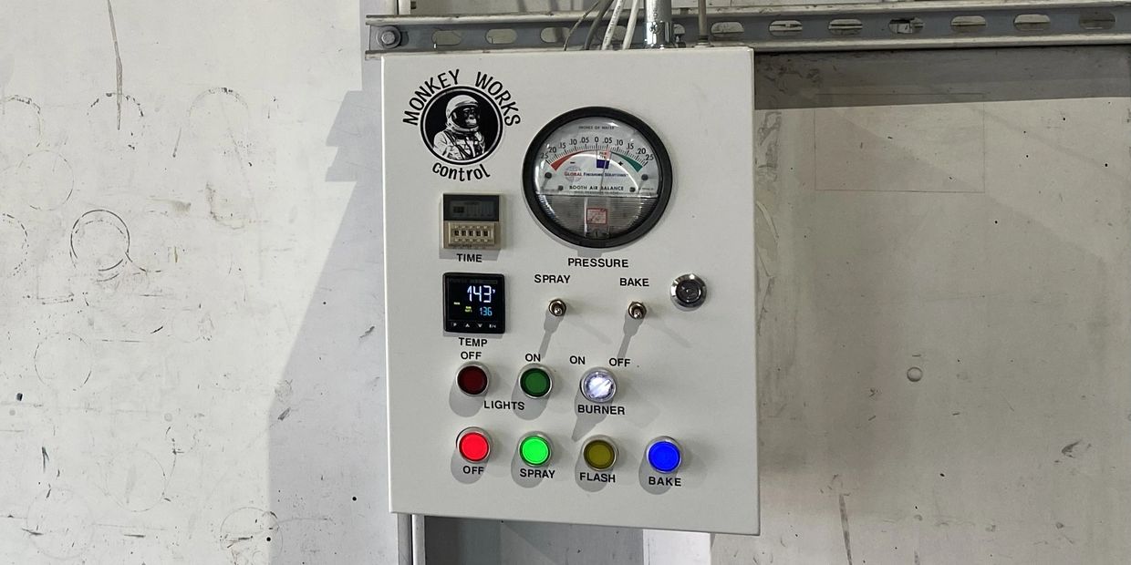 Industrial control panel with various buttons and a pressure gauge labeled 'Monkey Works'.