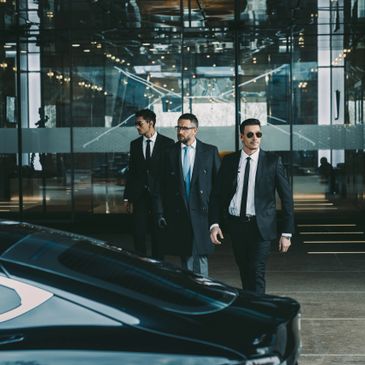 Two bodyguards walking with executive client