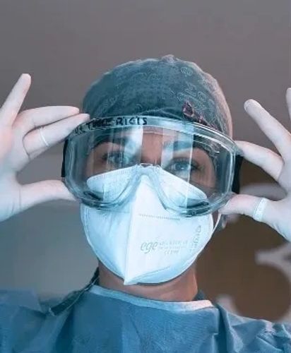 A dentist wearing dental loupes at WestDent clinic -UK Hub that provides full mouth implants treatment.