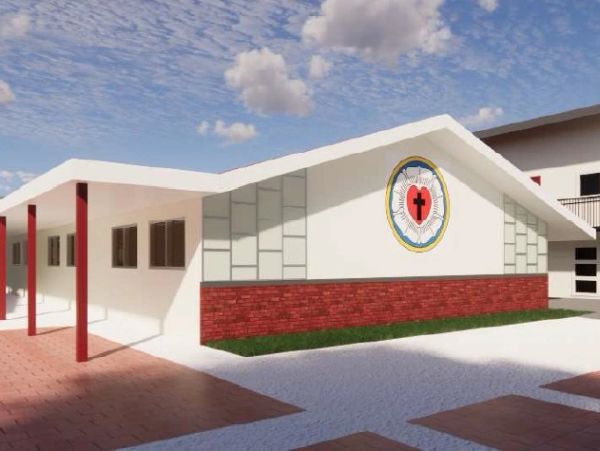 Modern church building with a cross emblem and red brick accents.