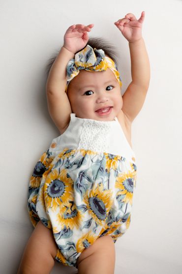 Baby girl smiles during her milestone photo session in Austin, Texas. 