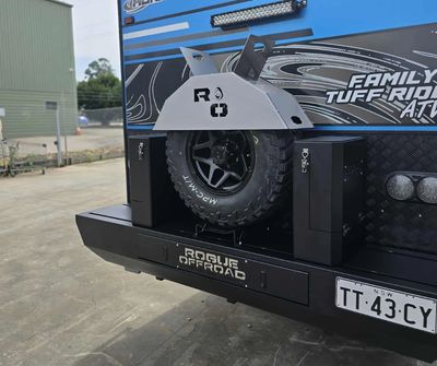 Rear view of an off-road vehicle with a spare tire and rugged bumper.