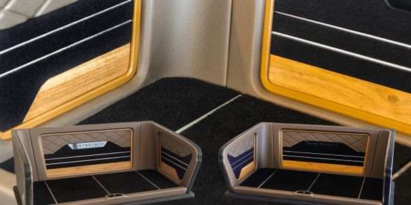 Luxury car interior with wood and leather detailing.