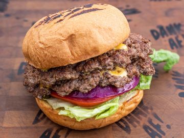 Classic American smash burger , lettuce, tomato, pickle, onion, brioche bun, American cheese 