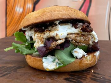 Chicken sandwich, goat cheese, arugula, sun dried tomatoes , lemon butter sauce, brioche bun 