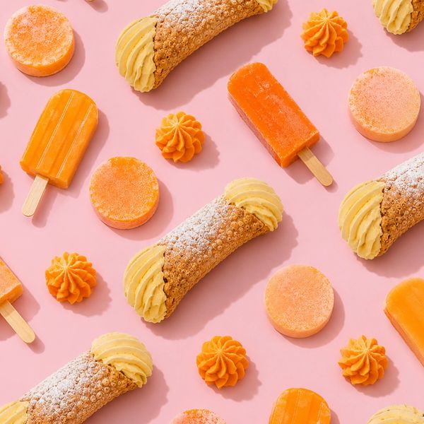 Pattern of orange-themed desserts on a pink background.