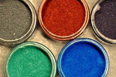 Image shows resin powder dye pots, used in making our products.
